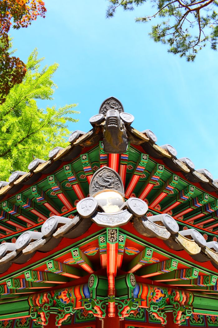 Intricately designed roof of a Korean Buddhist temple with vibrant colors.